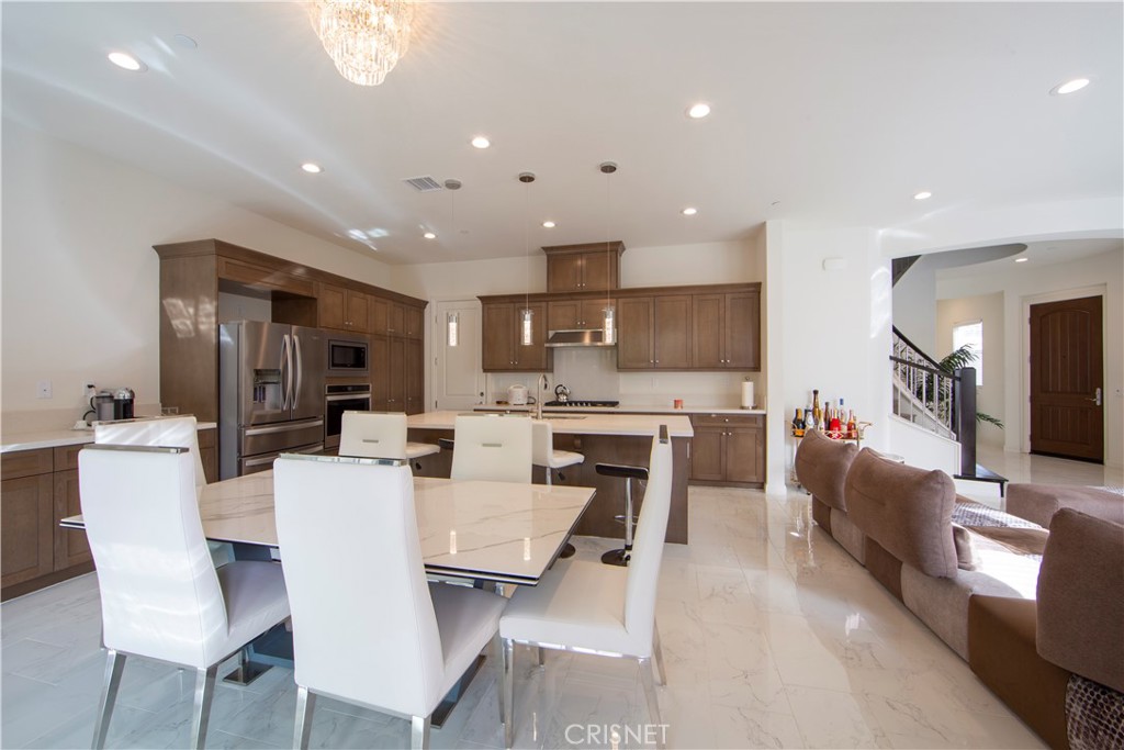 20800 Pine Cone Circle Porter Ranch, CA 91326 - Photo 11 of 43 a view of kitchen with dining table wooden floor dining table a sink and stainless steel appliances