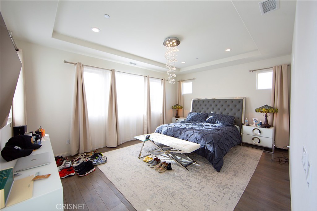 20800 Pine Cone Circle Porter Ranch, CA 91326 - Photo 17 of 43 a bedroom with furniture and a window