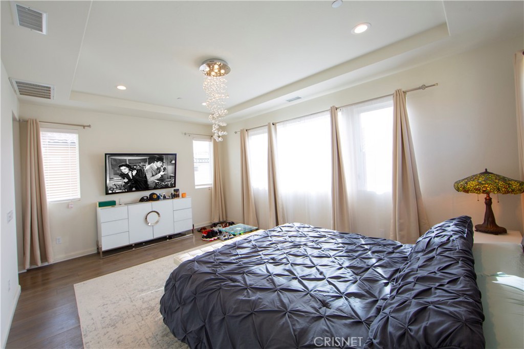 20800 Pine Cone Circle Porter Ranch, CA 91326 - Photo 18 of 43 a bedroom with a bed and a flat screen tv