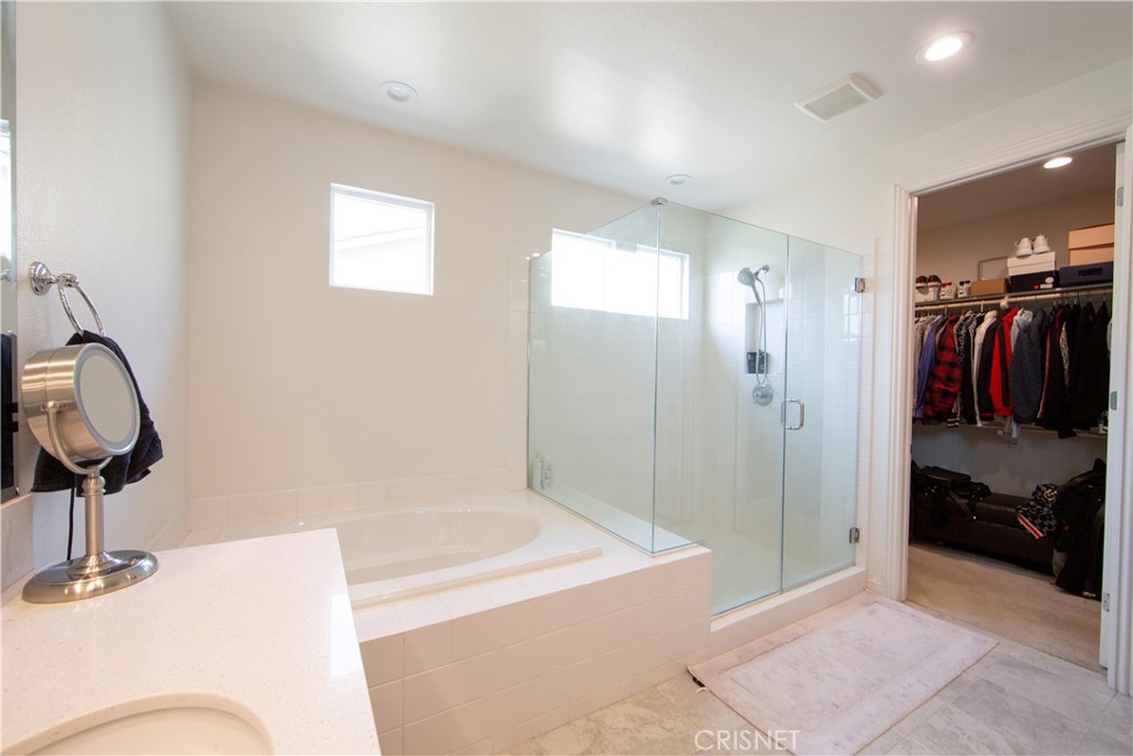 20800 Pine Cone Circle Porter Ranch, CA 91326 - Photo 20 of 43 a bathroom with a tub and shower
