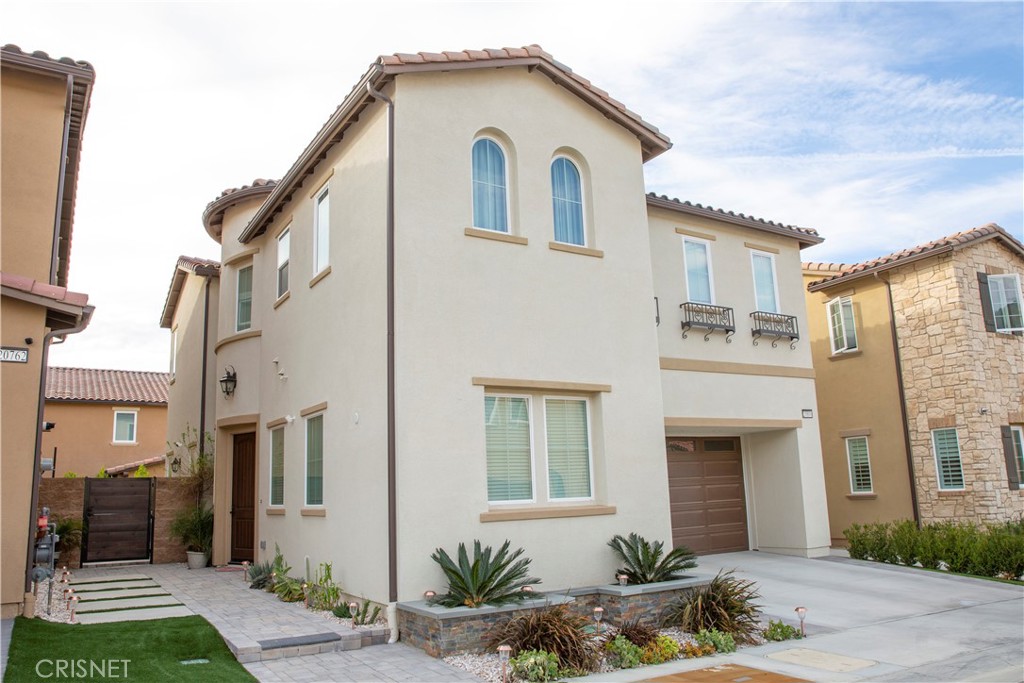 20800 Pine Cone Circle Porter Ranch, CA 91326 - Photo 2 of 43 a front view of a house with garden