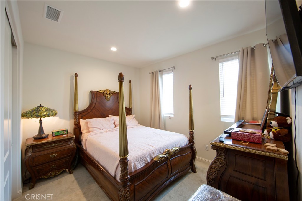 20800 Pine Cone Circle Porter Ranch, CA 91326 - Photo 24 of 43 a bedroom with a bed and a flat tv screen on dresser