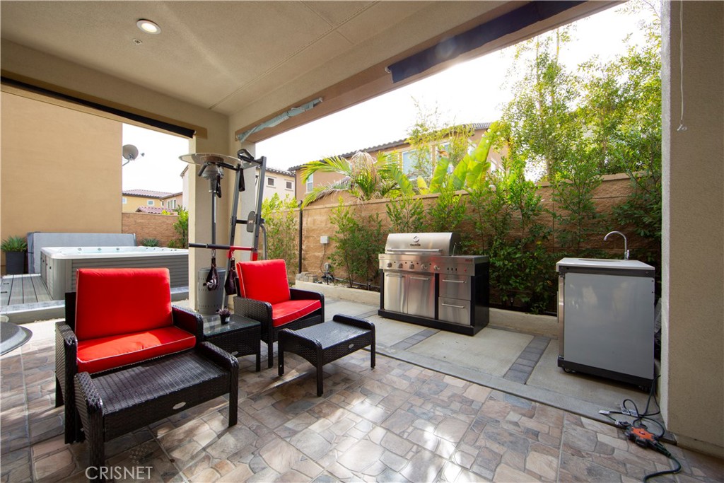 20800 Pine Cone Circle Porter Ranch, CA 91326 - Photo 29 of 43 a living room with patio furniture and a potted plant