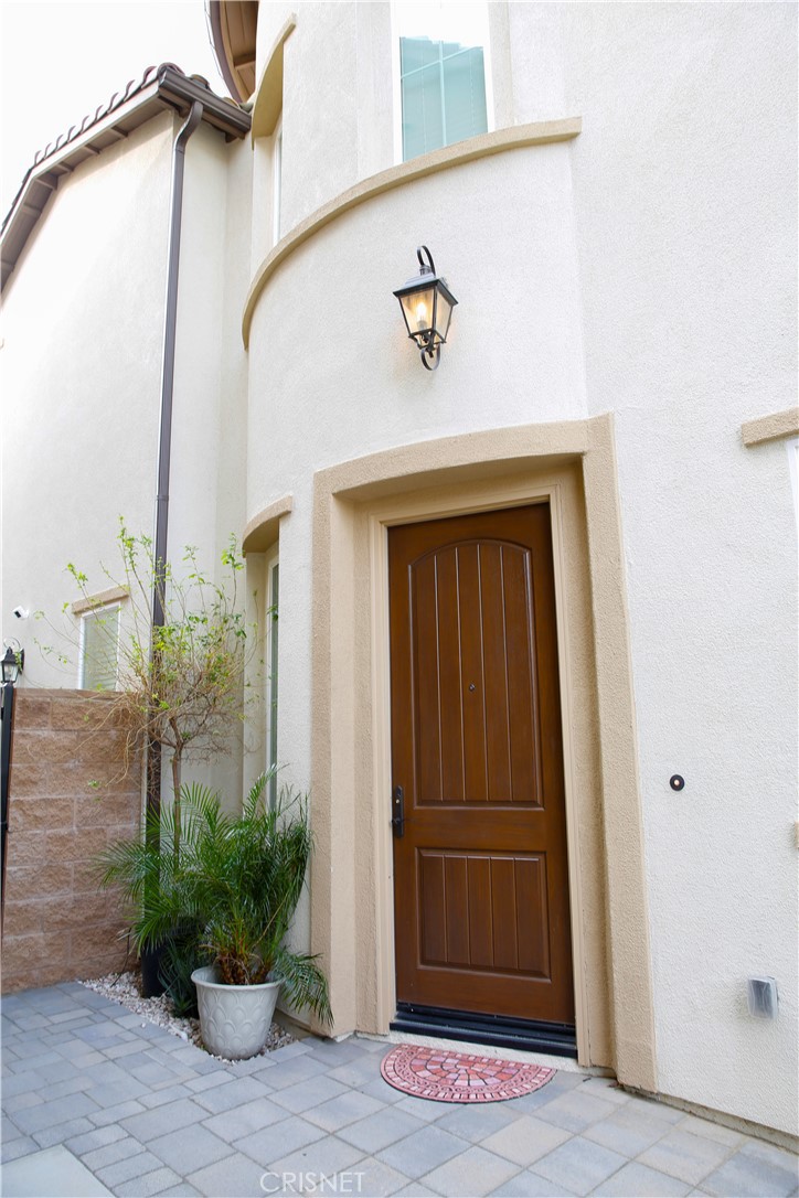 20800 Pine Cone Circle Porter Ranch, CA 91326 - Photo 3 of 43 a door view with a potted plants