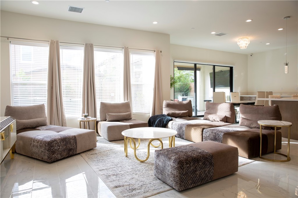 20800 Pine Cone Circle Porter Ranch, CA 91326 - Photo 7 of 43 a living room with furniture and large windows