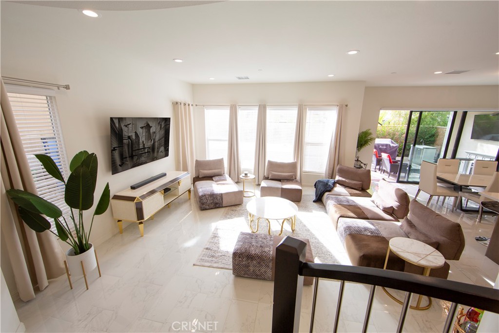 20800 Pine Cone Circle Porter Ranch, CA 91326 - Photo 10 of 43 a living room with furniture and a flat screen tv