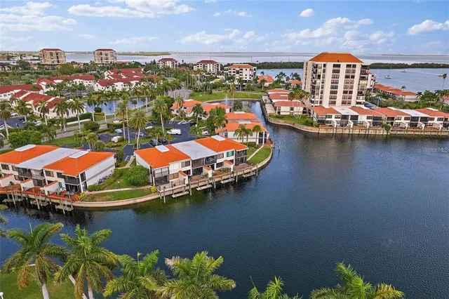 an aerial view of residential houses with outdoor space lake view and boat
