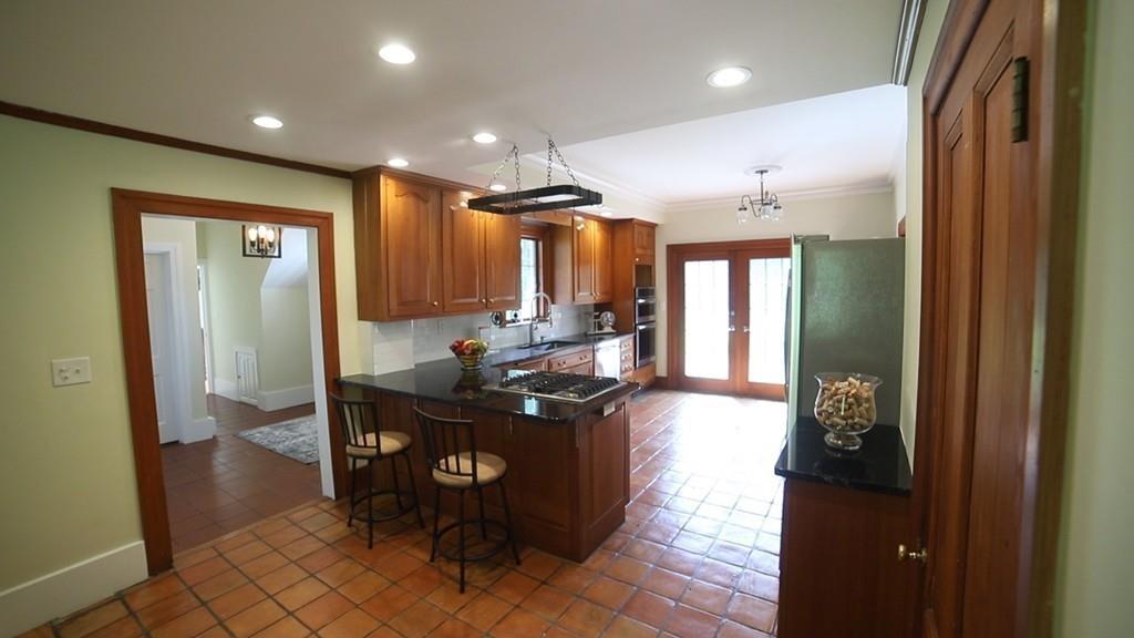 457 Edmands Road Framingham, MA 01701 - Photo 12 of 31 a kitchen with stainless steel appliances kitchen island granite countertop a refrigerator and a sink