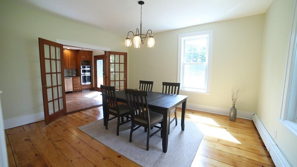 457 Edmands Road Framingham, MA 01701 - Photo 15 of 31 a view of a dining room with furniture wooden floor and chandelier
