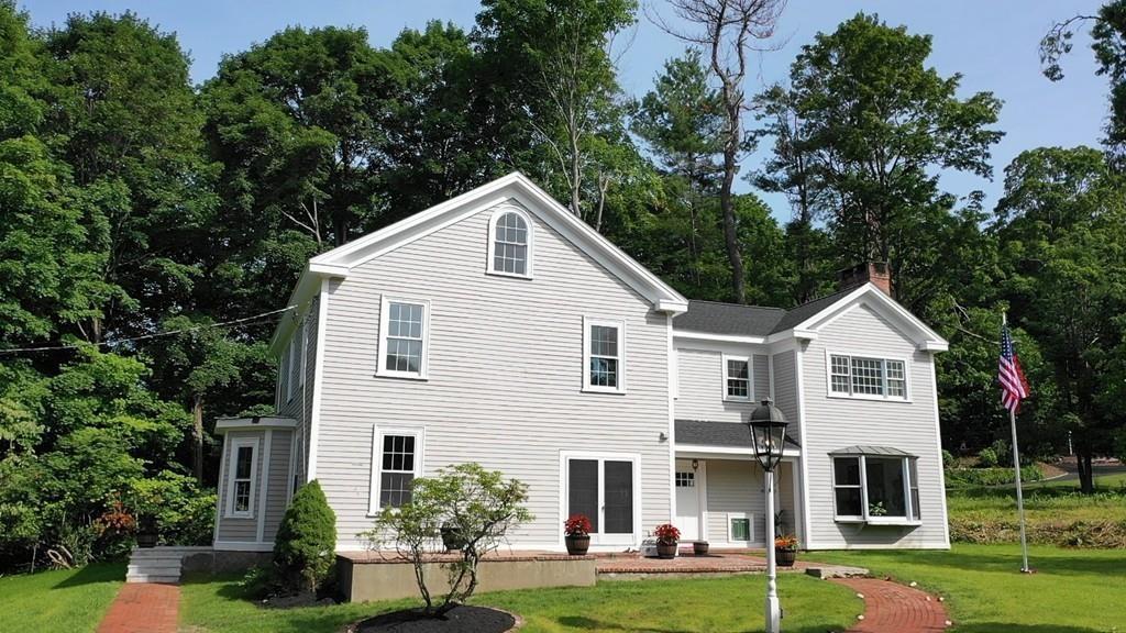 457 Edmands Road Framingham, MA 01701 - Photo 4 of 31 a view of a white house next to a yard with big trees