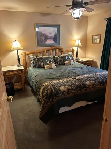 a bedroom with a bed and a lamp
