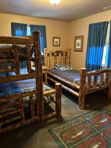 a bedroom with furniture and a mirror