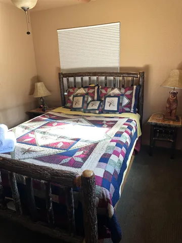 a bedroom with a bed and a table