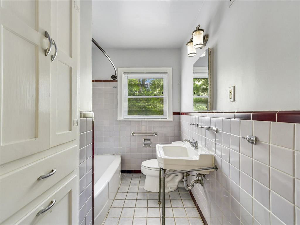 2323 Hartford Road, Unit A Austin, TX 78703 - Photo 14 of 15 Classic tiling and a vintage pedestal sink define this charming bathroom layout.