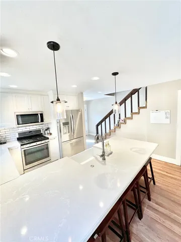 a kitchen with stainless steel appliances kitchen island a island in the center
