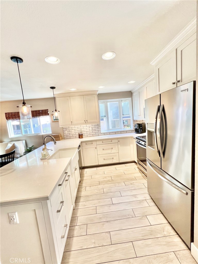 82 Canyon Terrace Road Avalon, CA 90704 - Photo 14 of 23 a large white kitchen with a refrigerator a stove and a sink