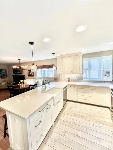 a large white kitchen with cabinets