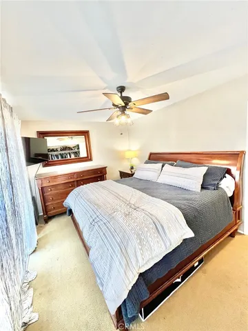 a bedroom with bed and window