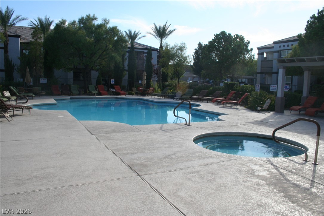 7255 West Sunset Road, Unit 1021 Las Vegas, NV 89113 - Photo 7 of 7 An inviting swimming pool and adjacent spa sit surrounded by a concrete sun deck.