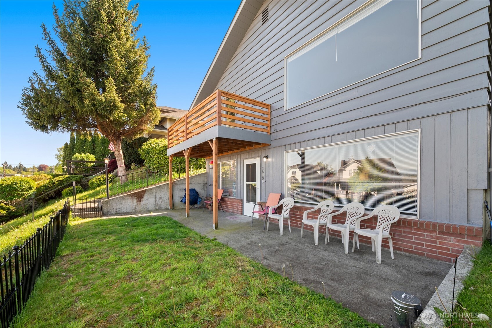 a view of a house with a chairs and table in a patio