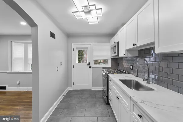 a kitchen with a sink cabinets and window