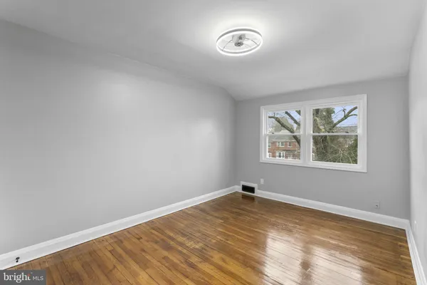 a view of a room with wooden floor and window