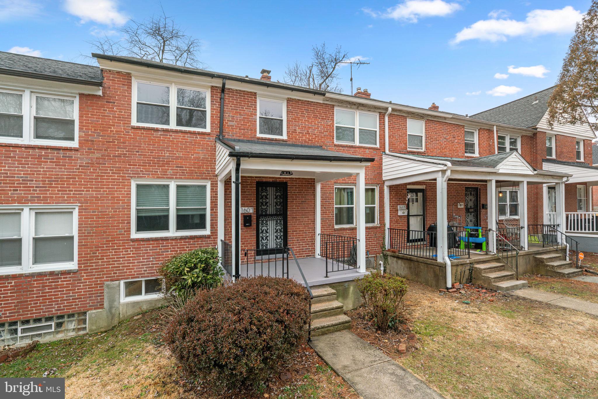 1607 Stonewood Road Baltimore, MD 21239 - Photo 2 of 53 a front view of a house with garden and porch