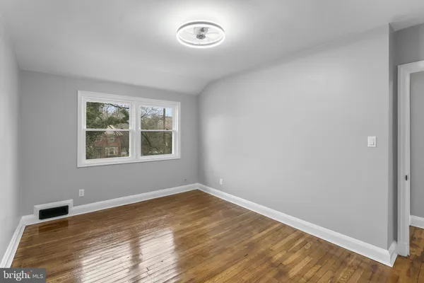 a view of room with wooden floor