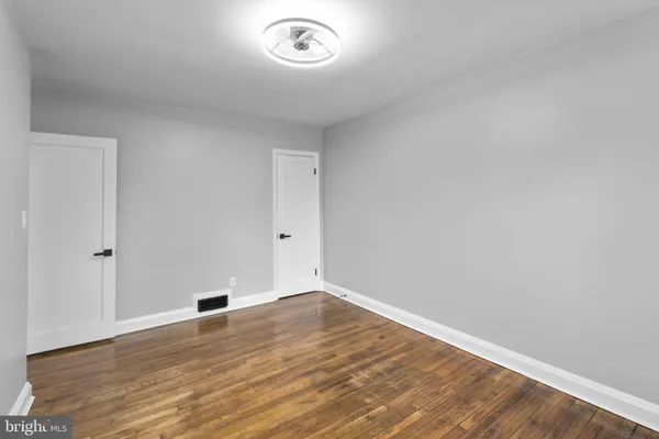 a view of room with window and wooden floor