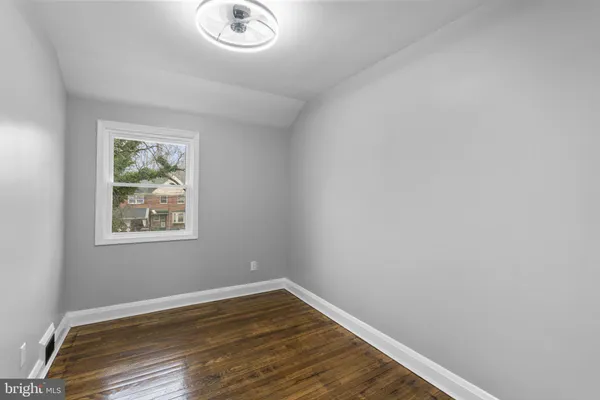 a view of room with window and hardwood floor