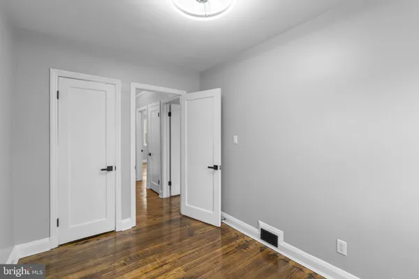 a view of a room with wooden floor