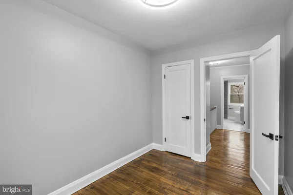 a bathroom with a toilet sink vanity and mirror
