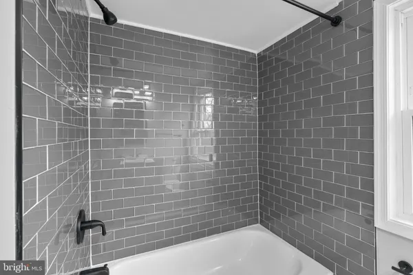 a bathroom with a sink a mirror a toilet and shower