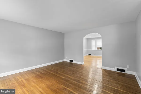 a view of empty room with wooden floor and lake view