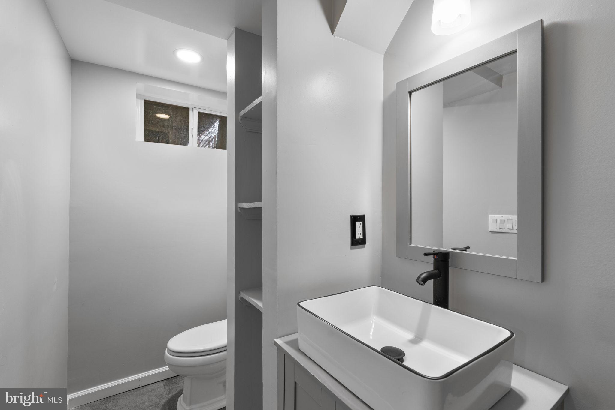 1607 Stonewood Road Baltimore, MD 21239 - Photo 38 of 53 a bathroom with a sink toilet and vanity