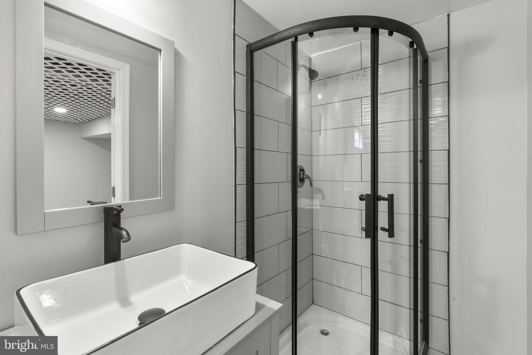 1607 Stonewood Road Baltimore, MD 21239 - Photo 39 of 53 a bathroom with a shower and a sink