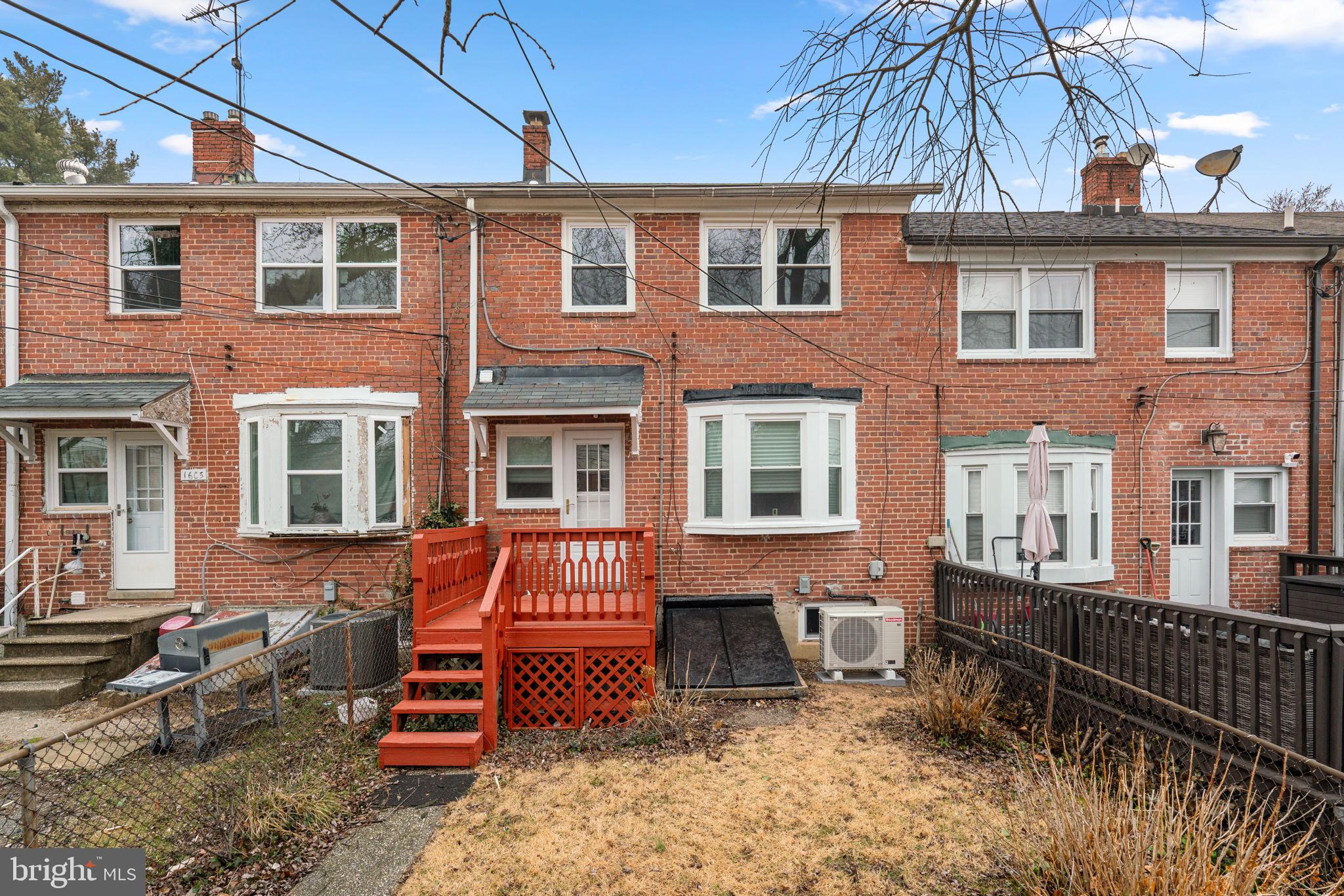 1607 Stonewood Road Baltimore, MD 21239 - Photo 40 of 53 a backyard of a house with barbeque oven table and chairs