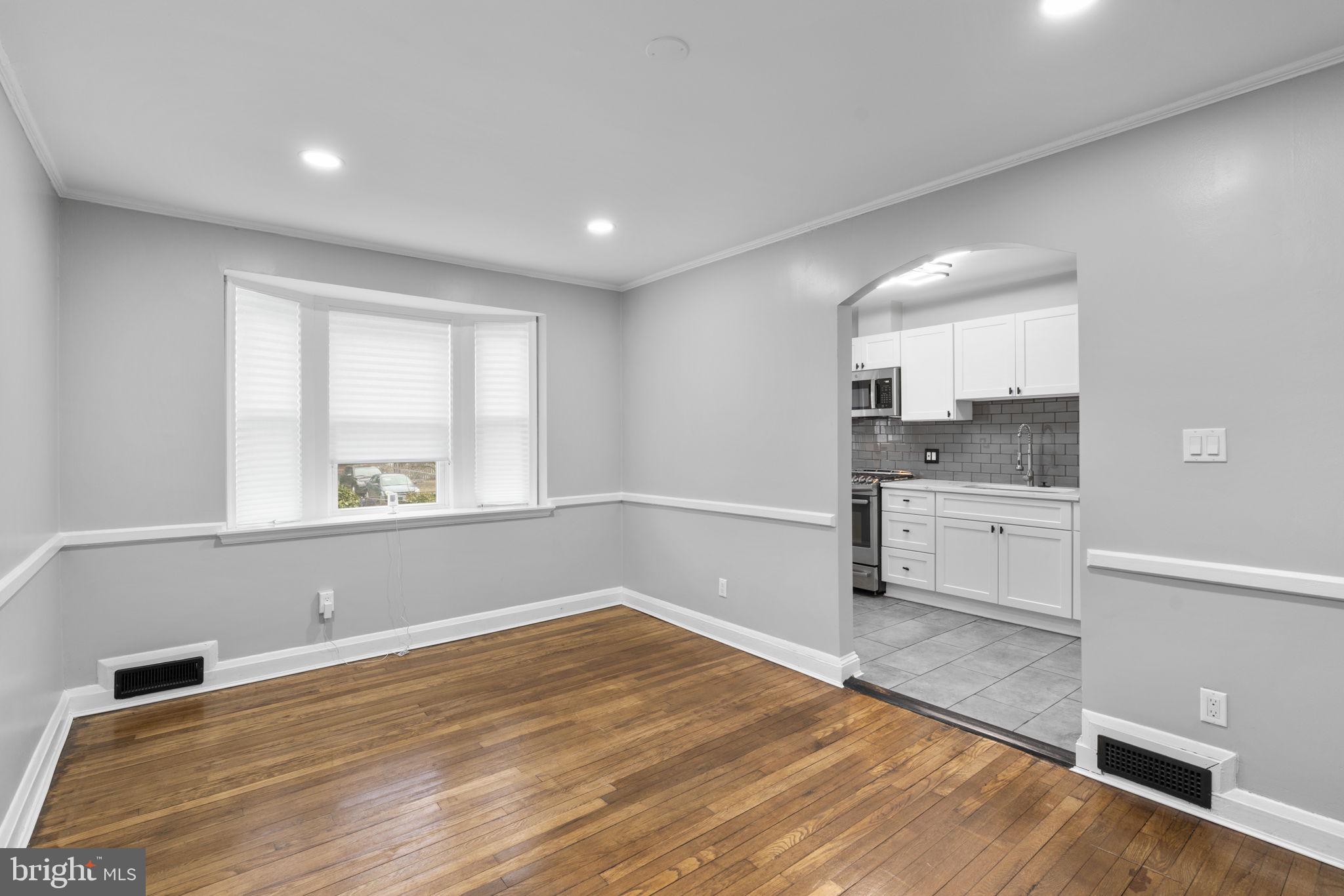 1607 Stonewood Road Baltimore, MD 21239 - Photo 8 of 53 a view of a kitchen with a sink and dishwasher wooden floor