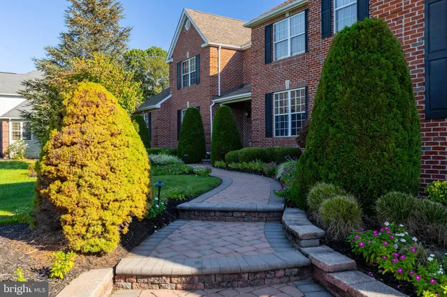 a view of a house with swimming pool and sitting area