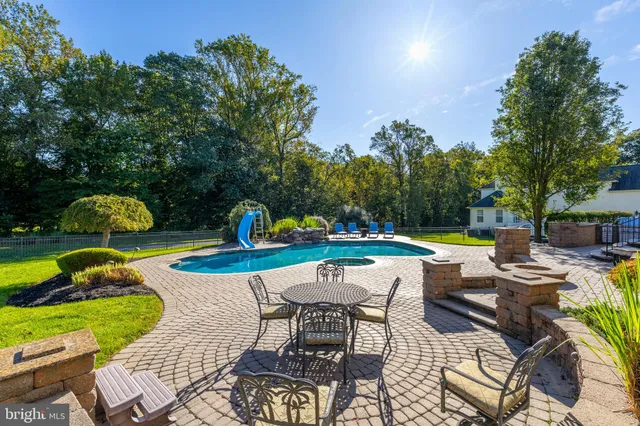 a kitchen with stainless steel appliances granite countertop a stove a sink a oven and a refrigerator