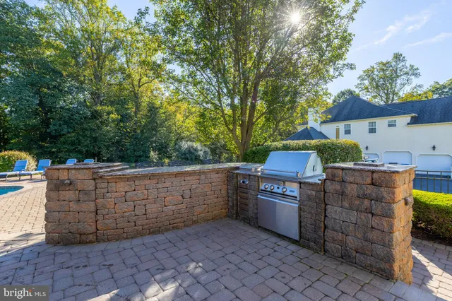a kitchen with kitchen island granite countertop a stove oven and a sink