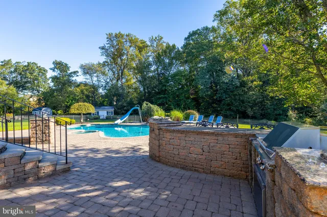 a large dining hall with stainless steel appliances granite countertop a table and chairs