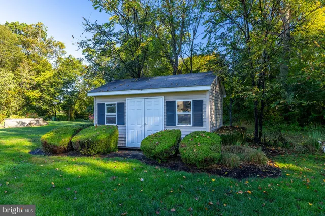 a living room with furniture a flat screen tv and a large window