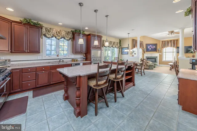 a spacious bathroom with a granite countertop sink a mirror and a bathtub