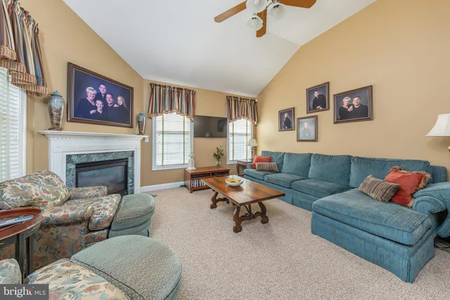 a spacious bathroom with a granite countertop sink a toilet a mirror and shower