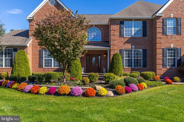 a group of people sitting in front of a house