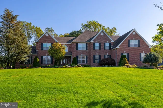 a front view of a house with plants and garden