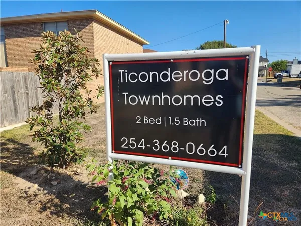 a sign broad in front of flowers