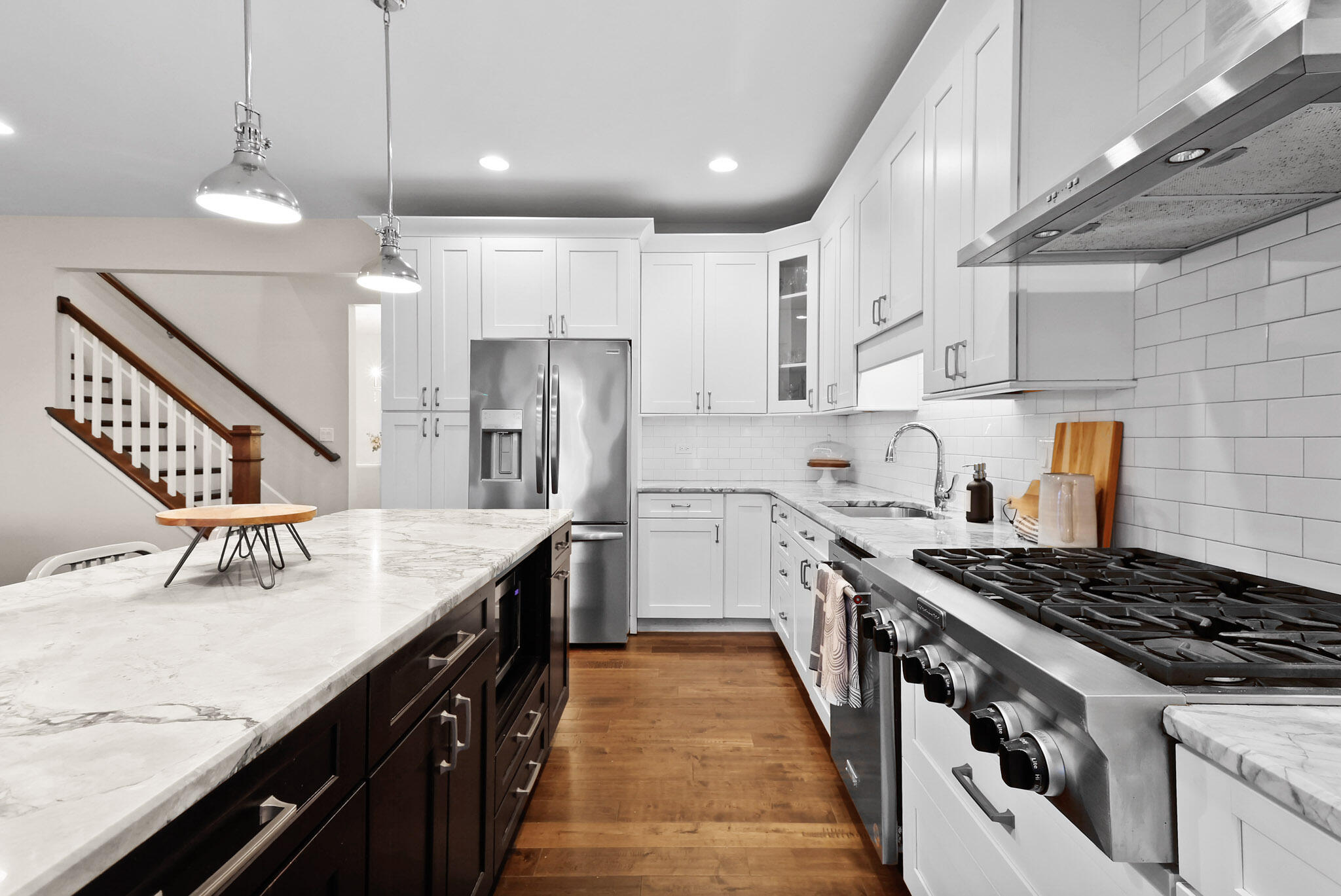 10230 Barbara Lane Munster, IN 46321 - Photo 12 of 47 a kitchen with granite countertop a sink a stove refrigerator and cabinets