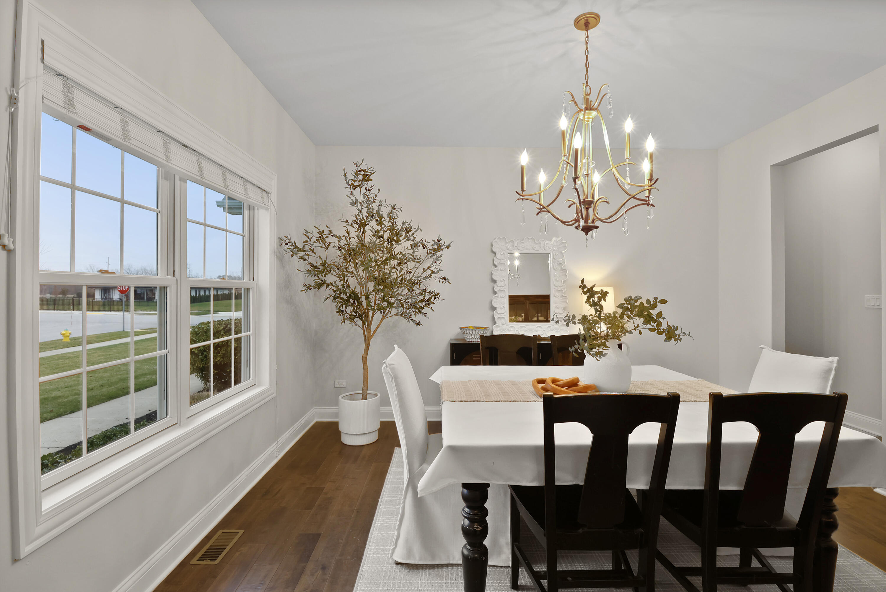 10230 Barbara Lane Munster, IN 46321 - Photo 14 of 47 a view of a dining room with furniture a chandelier and wooden floor